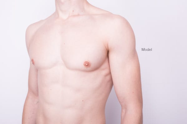 Body shot of a shirtless male model with a muscle body