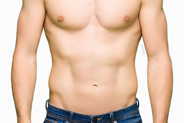 Mid body shot of a shirtless male model with a thinber muscular build