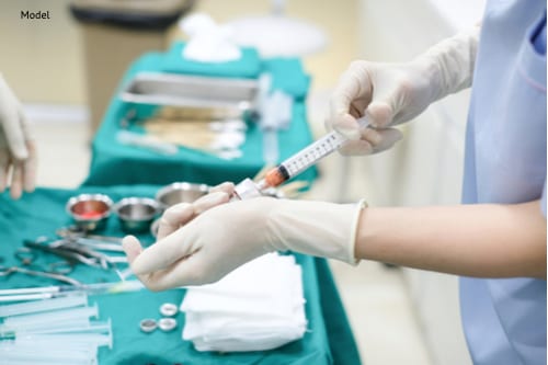 Hands Holding Syringes for Transfer Fat while Operating-img-blog