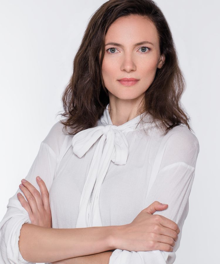 Woman crossing her arms wearing white clothes